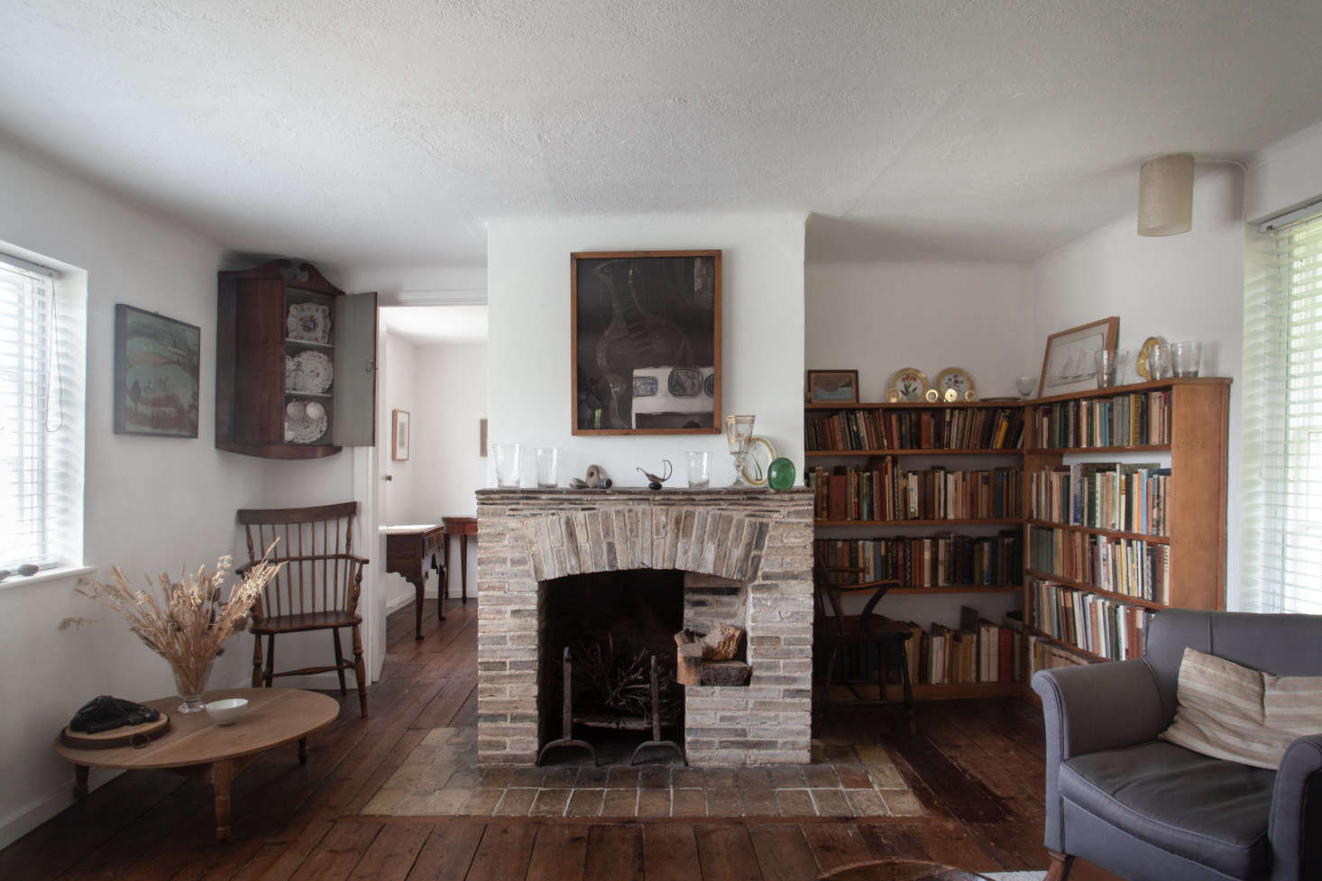 A view of the second fireplace and reading corner in the upstairs level of the old cottage.