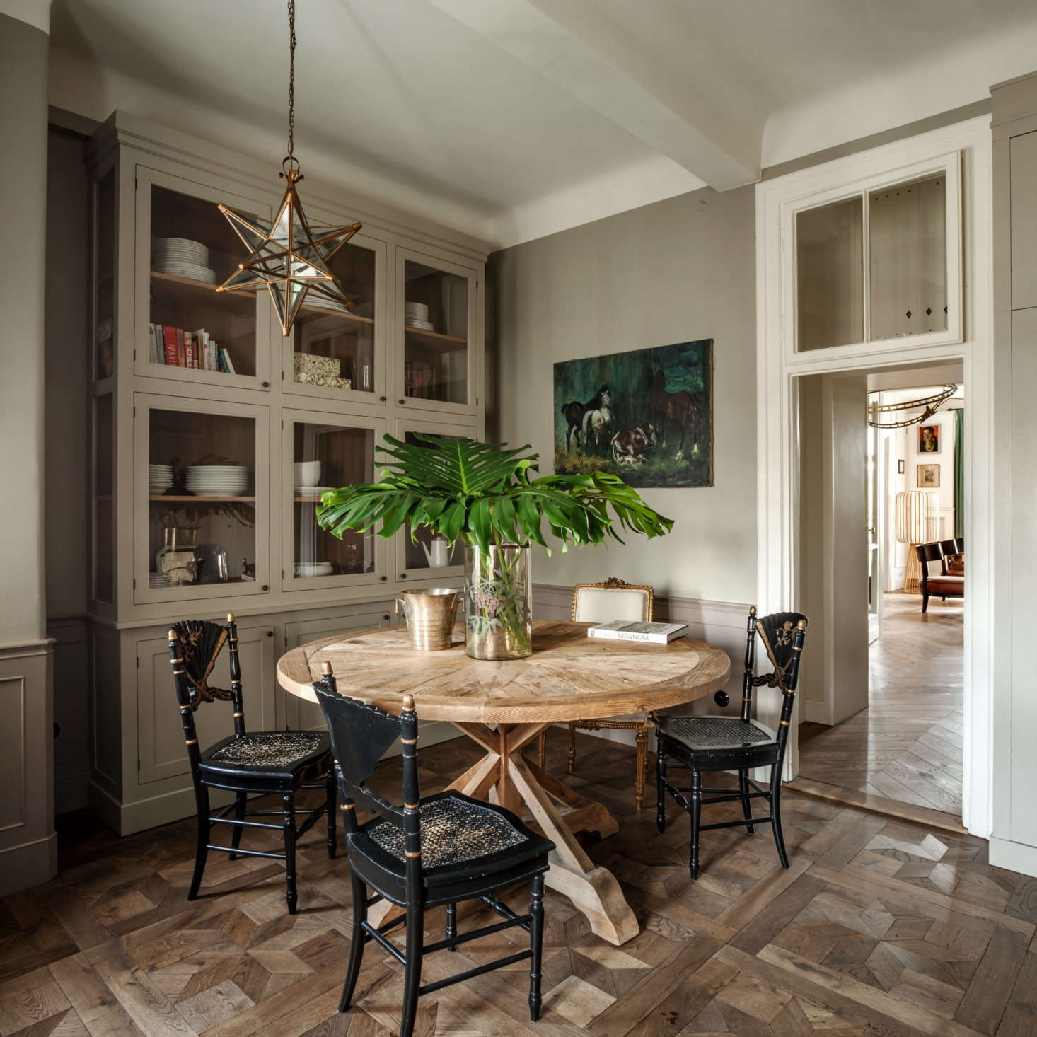 The oak flooring in the rest of the home is laid in Hungarian point, but Chrapka chose an etoile pattern for the kitchen.