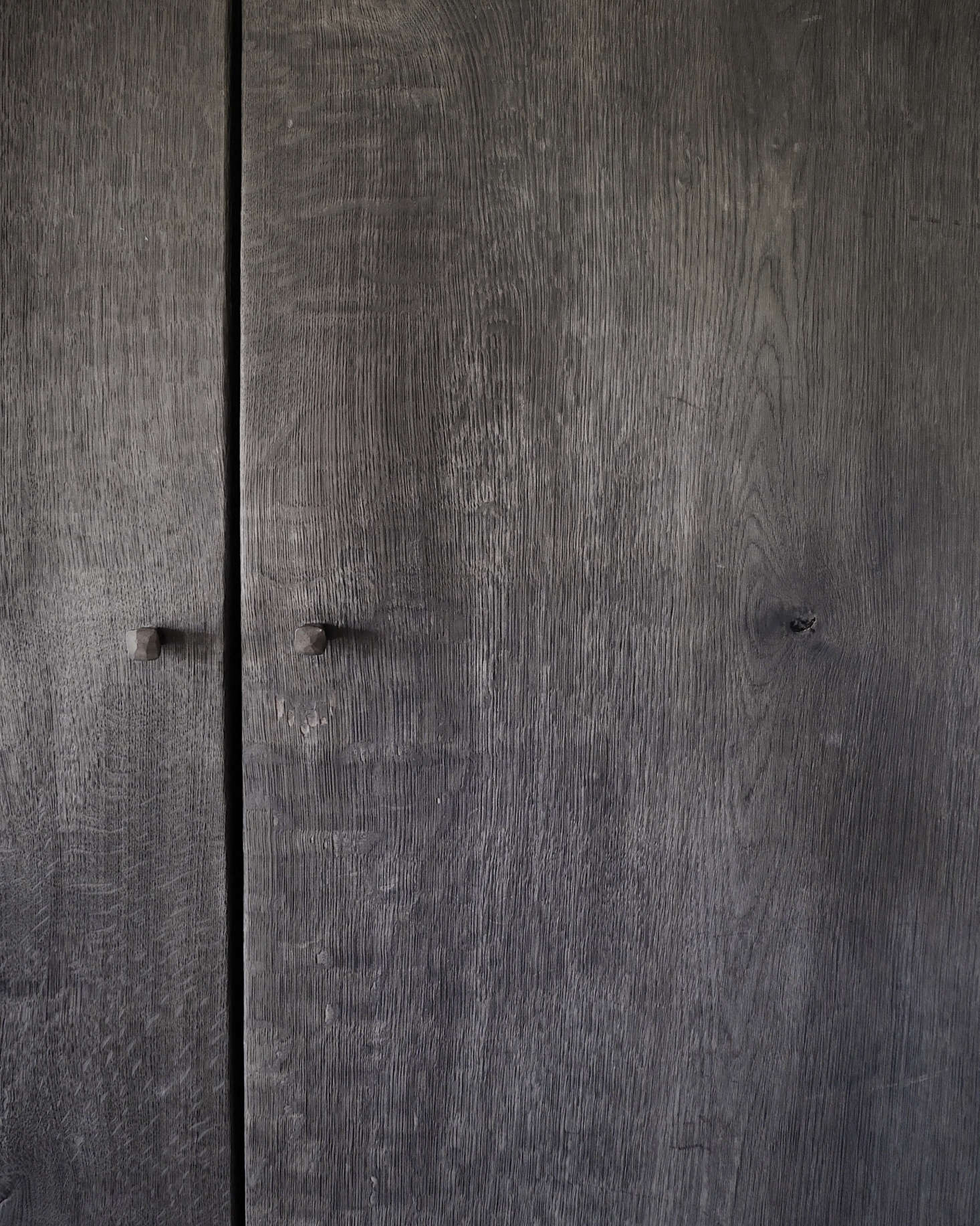 Hand-forged nails serve as knobs on the bedroom wardrobes made by Belgian designer/reclamation dealer Joris Van Apers.