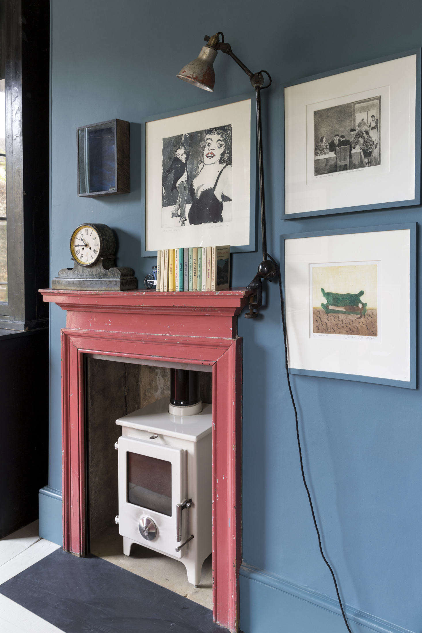 An antique mantel in its original paint was added to the room along with a wood-burning stove and vintage workman