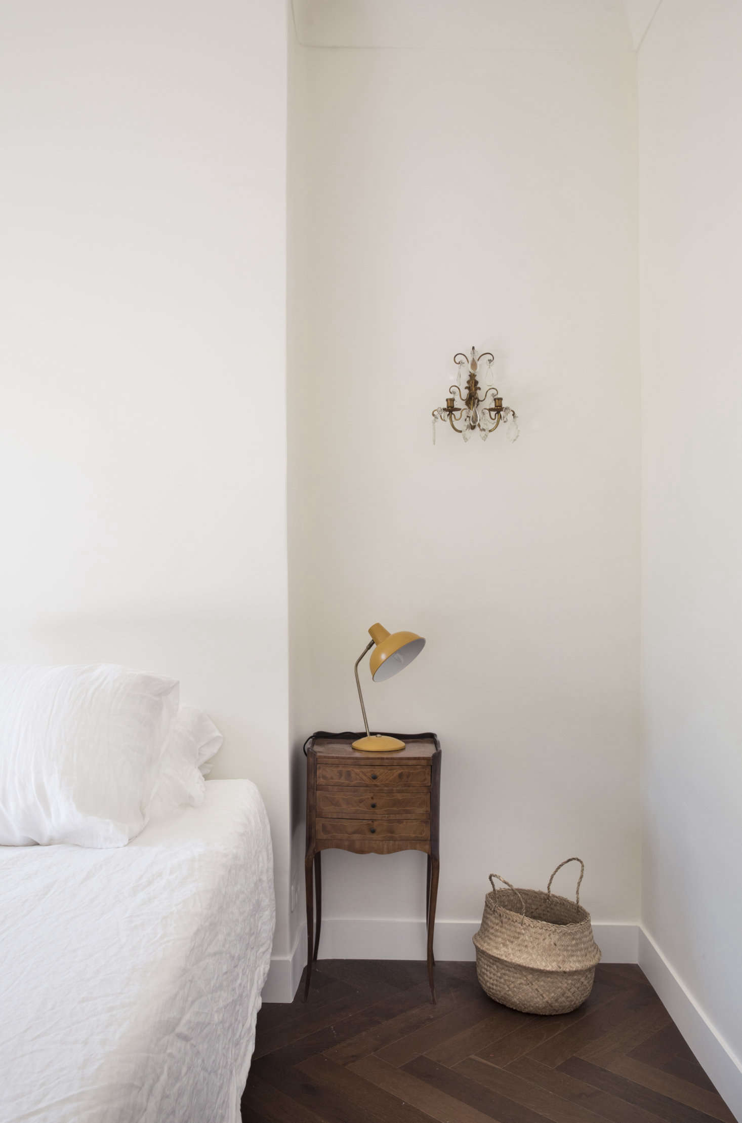The bedside tables are from the Antibes brocante market and the sconces are from Cours Saleya in Nice.