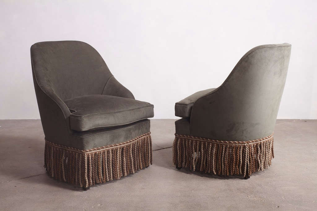 Spotted everywhere lately: fringe-trimmed lounge chairs; shown above is a pair of Cover Fireplace Pull-Up Chair with wool bullion fringe skirting from LA designers Nickey Kehoe.