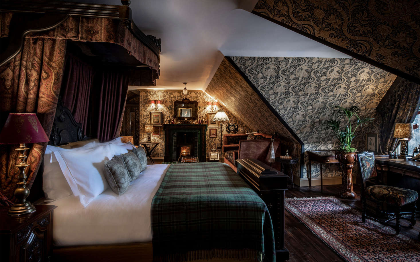 Another royal suite, done floor-to-ceiling in patterned wallpaper, with the requisite tartan blanket.