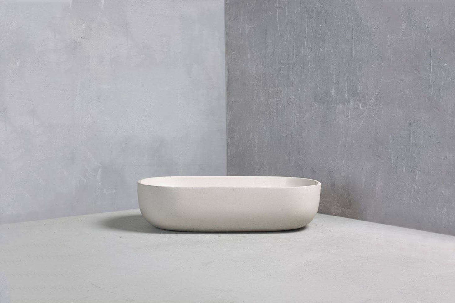 The antique stone wash basin in the bathroom is one-of-a-kind sourced by Chan & Eayrs. For a similar shape, the Bert & May Rho Basin made in collaboration with British maker Kast out of colored concrete basin—shown in Limestone; £data-src=