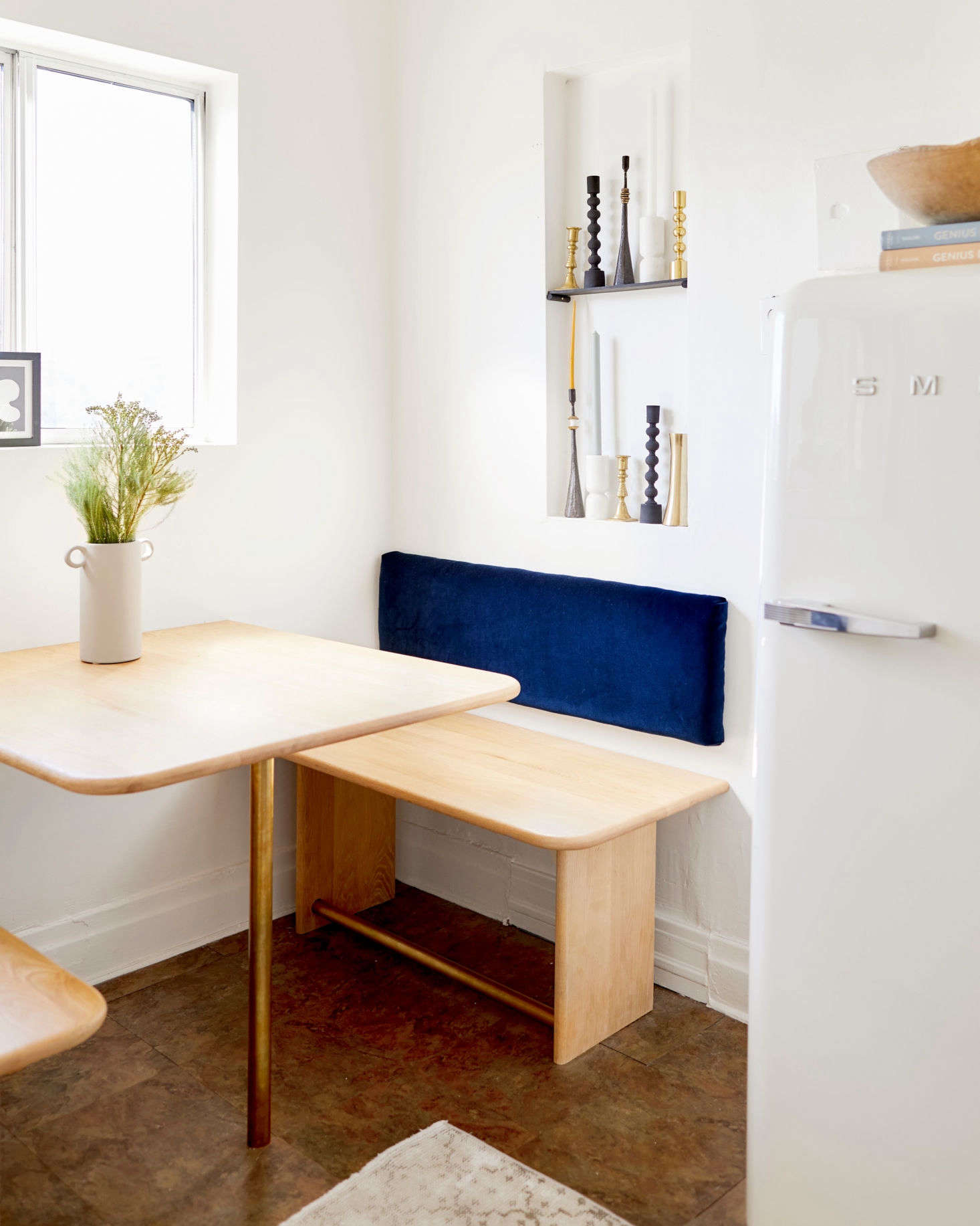 At a cost of about $750, the nook was Jessica’s biggest splurge (the Smeg was gifted). “I purchased 10 red oak stair treads—that’s where the bullnose edges came into play—that I then graciously passed over to my dad, along with my design plan. The brass bars are curtain rods and the back cushions I made with fabric, foam, wood, and a staple gun,” shares Jessica.