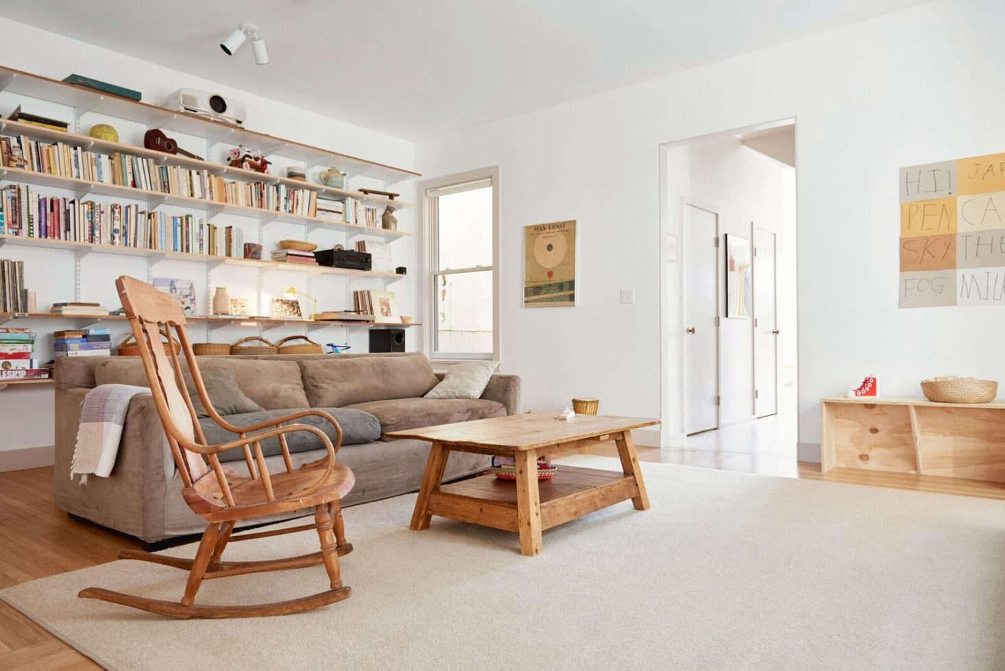 The interiors are painted Benjamin Moore Chantilly Lace (on walls) and Sherwin-Williams Ghost Pines (on trim) throughout the home. The rug is a 0 percent wool remnant from California Carpet, cut to size and bound. The wood floors here are original to the house.