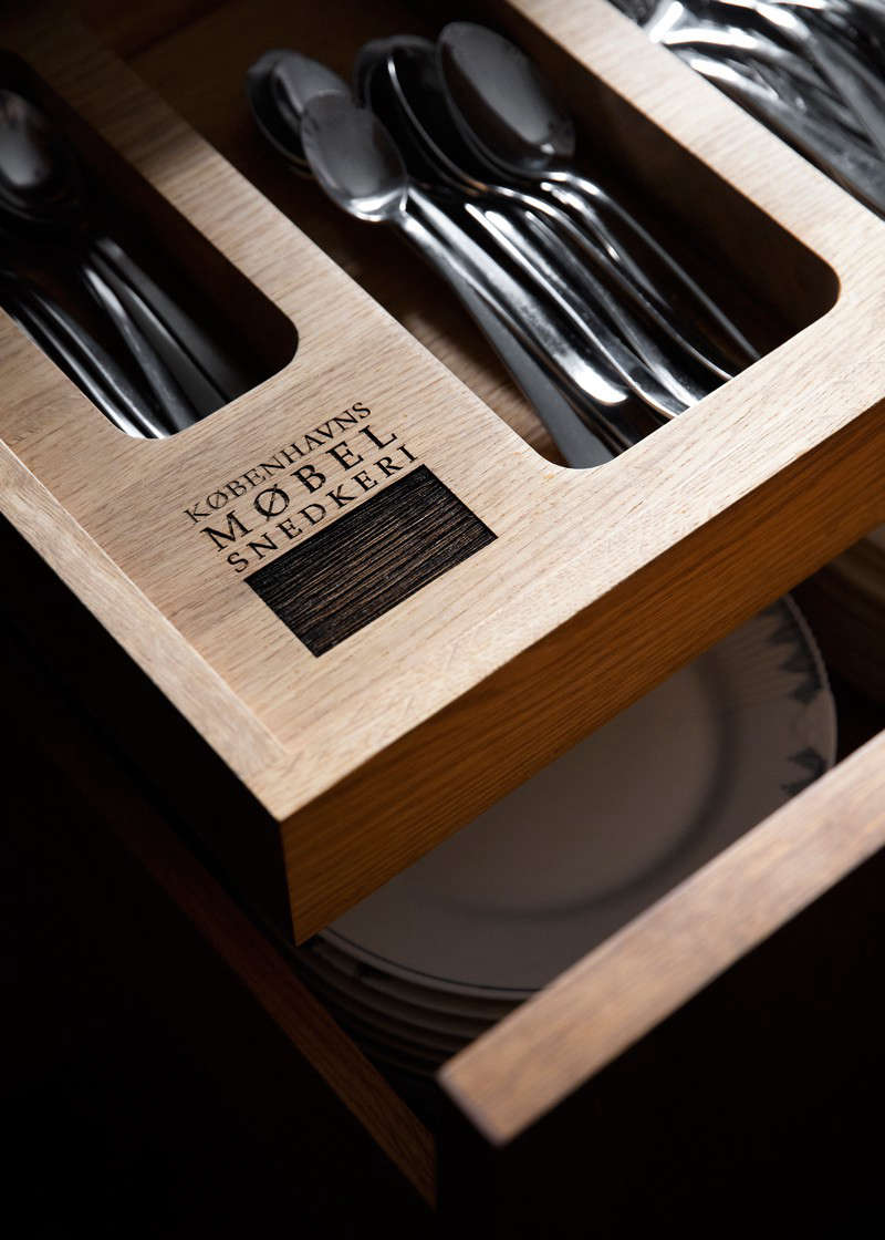 Custom cutlery drawers are one of KBH Københavns Møbelsnedkeri’s signature touches.