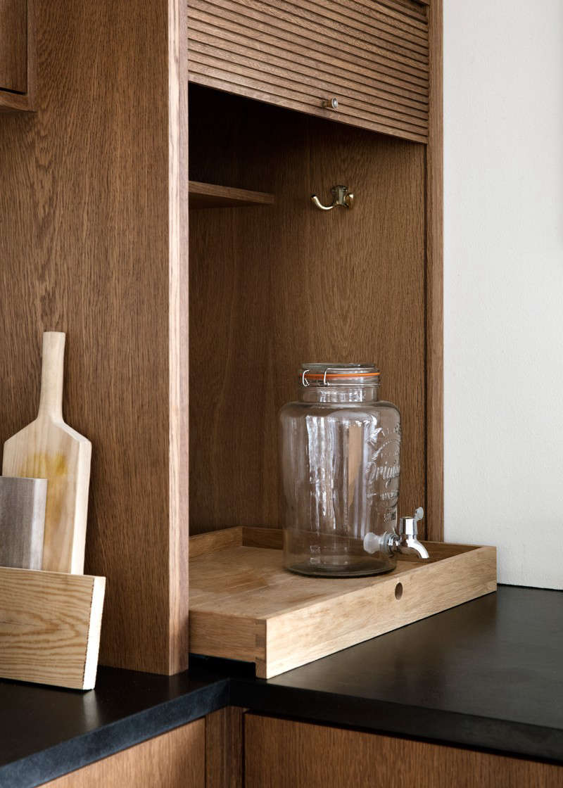 “When the cupboard is pulled up, there’s space for our kitchen machines and equipment on a pullout tray—very practical,” says Rebecca. (For drinks dispensers like this one, see 10 Easy Pieces.)