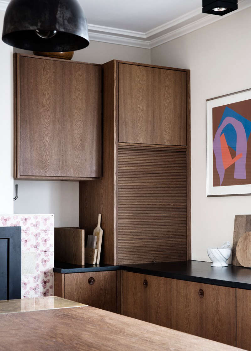 On the other side of the fireplace, the over-the-counter storage includes the aforementioned appliance garage (also known as a tambour cupboard).