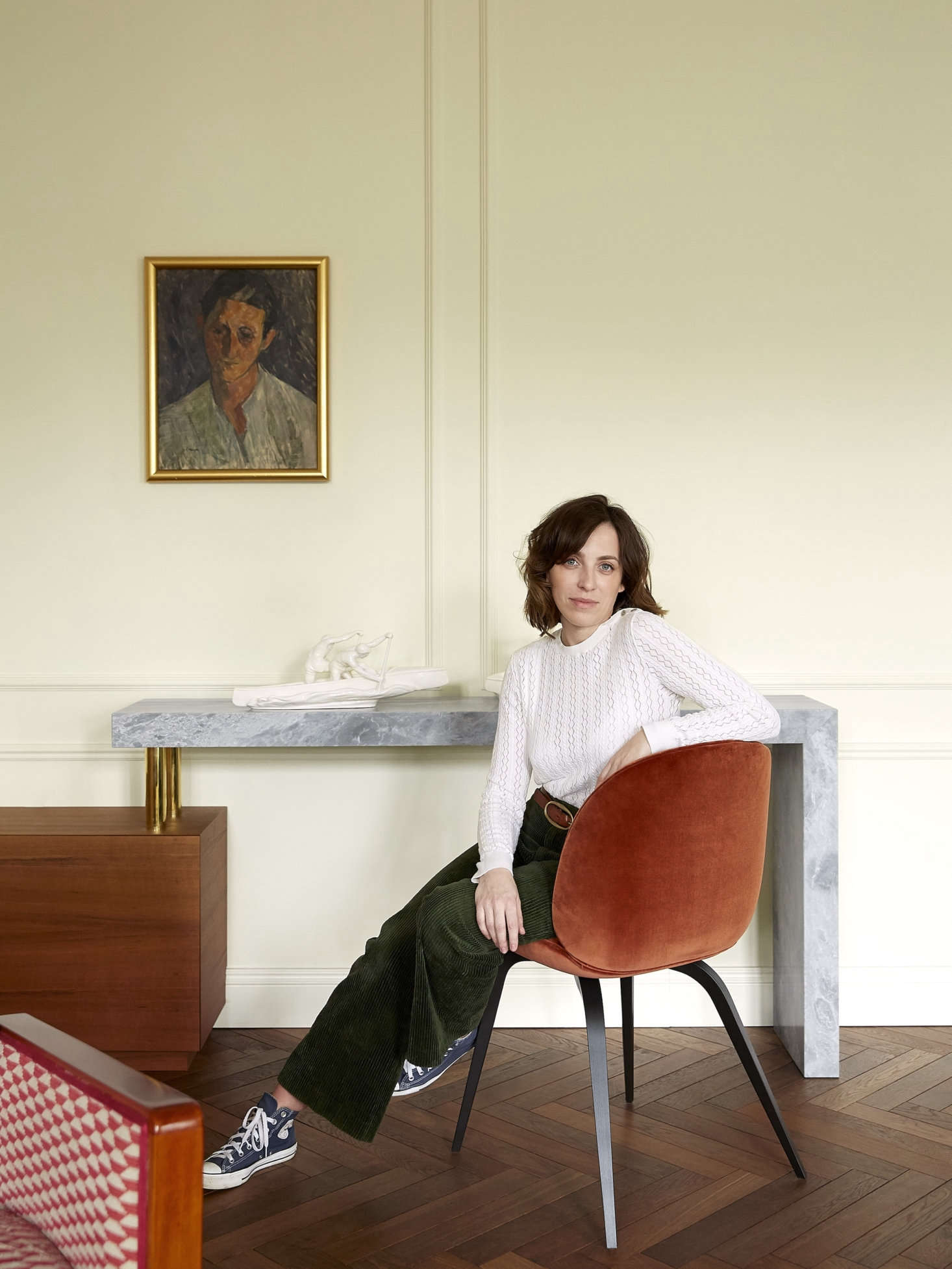 The cabinet culiminates in a marble console/desk. Chrapka, pictured, who graduated from the European Academy of Art in Warsaw, has a painterly eye when it comes to colors. The white on the walls in the living room is JdM White from Belgian paint company Emente.