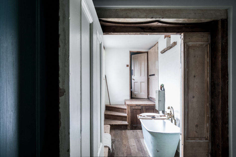 At the foot of the stairs is a pass-through bathing area that leads to the two bedrooms.