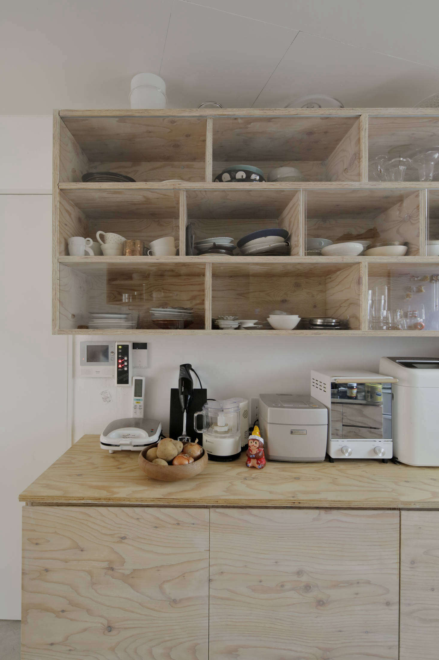 Sliding glass fronts keep the contents of the compartments clean.
