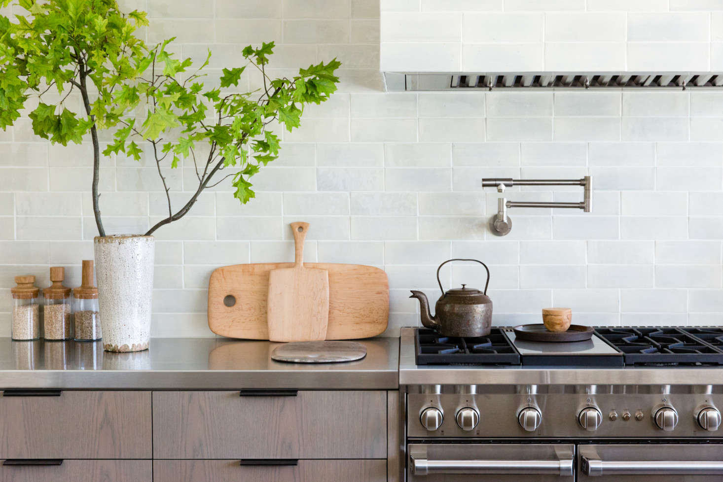 The back counter is brushed stainless steel. Note the pot-filler faucet above the range: see Domestic Dispatches: Why Your Kitchen Needs a Pot Filler Faucet.