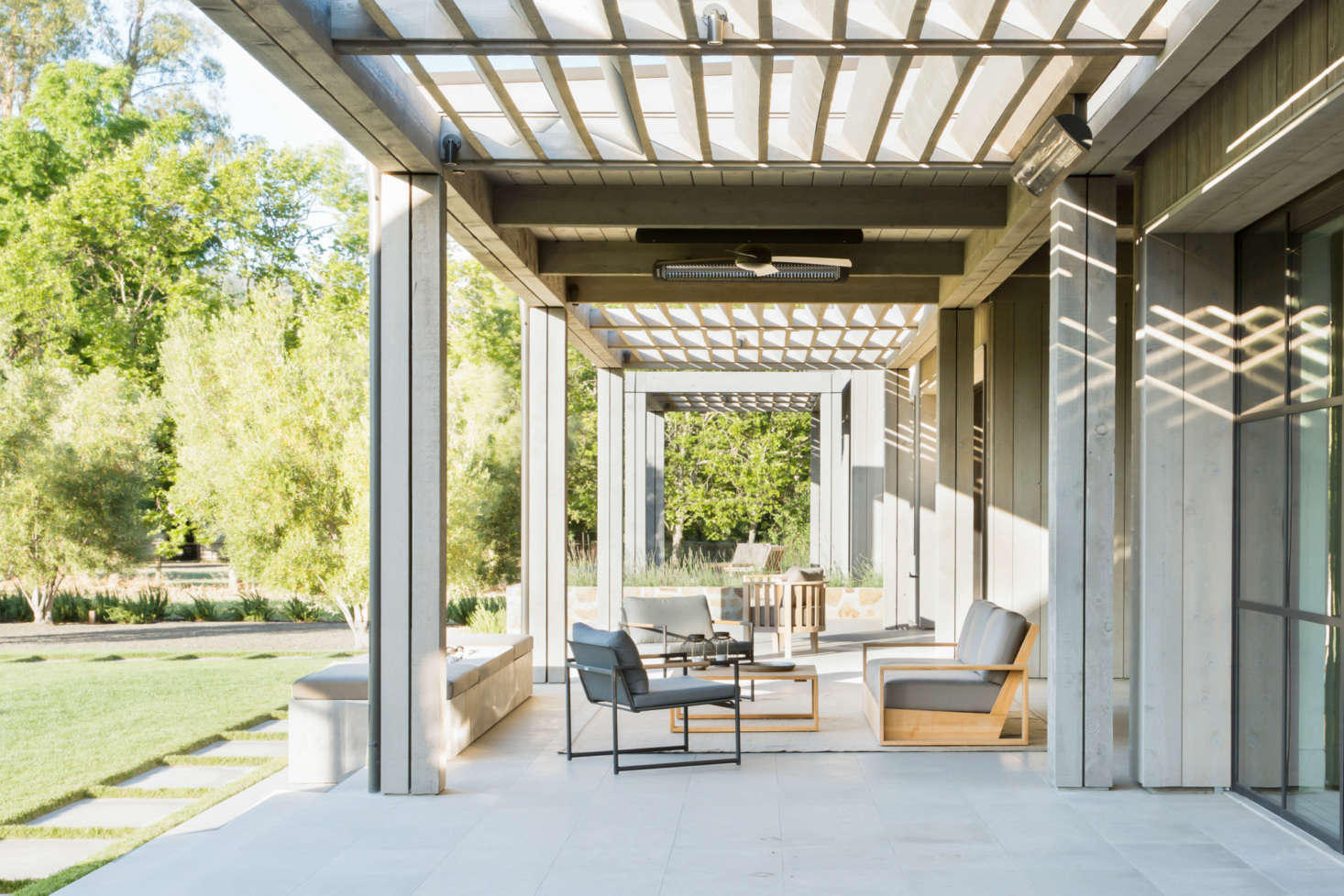 The series of indoor rooms leads directly to outdoor living spaces.