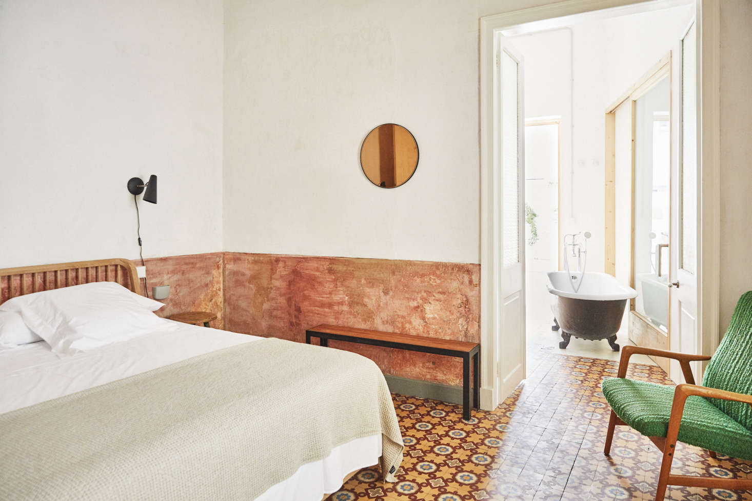 The pink paint on the lower half of the bedroom walls is original to the building.