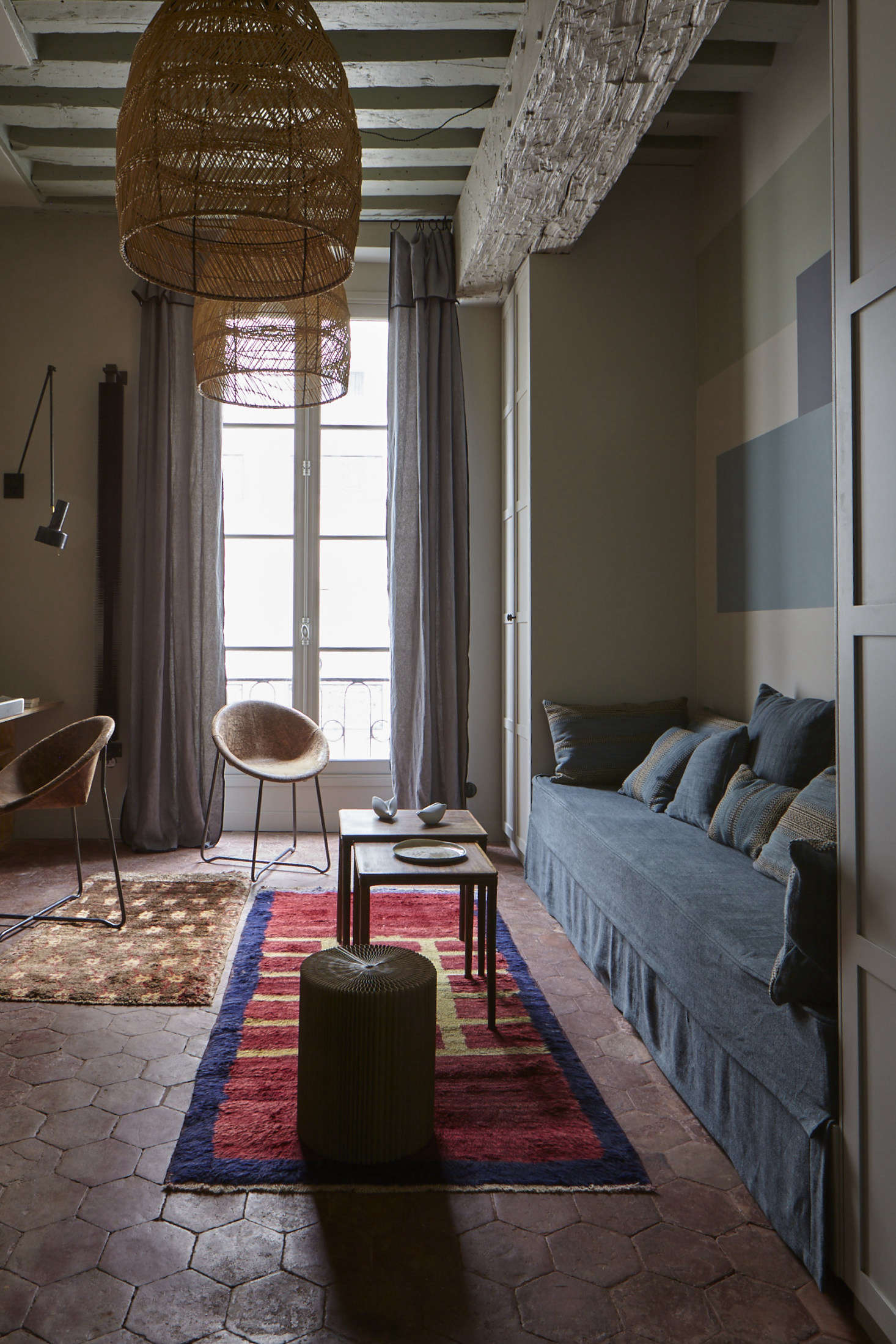 True to style, Evennou worked her color magic, balancing blues with reds and rusts, including the original terra cotta tiles. The rattan pendant lights are from Cinq Étoiles.