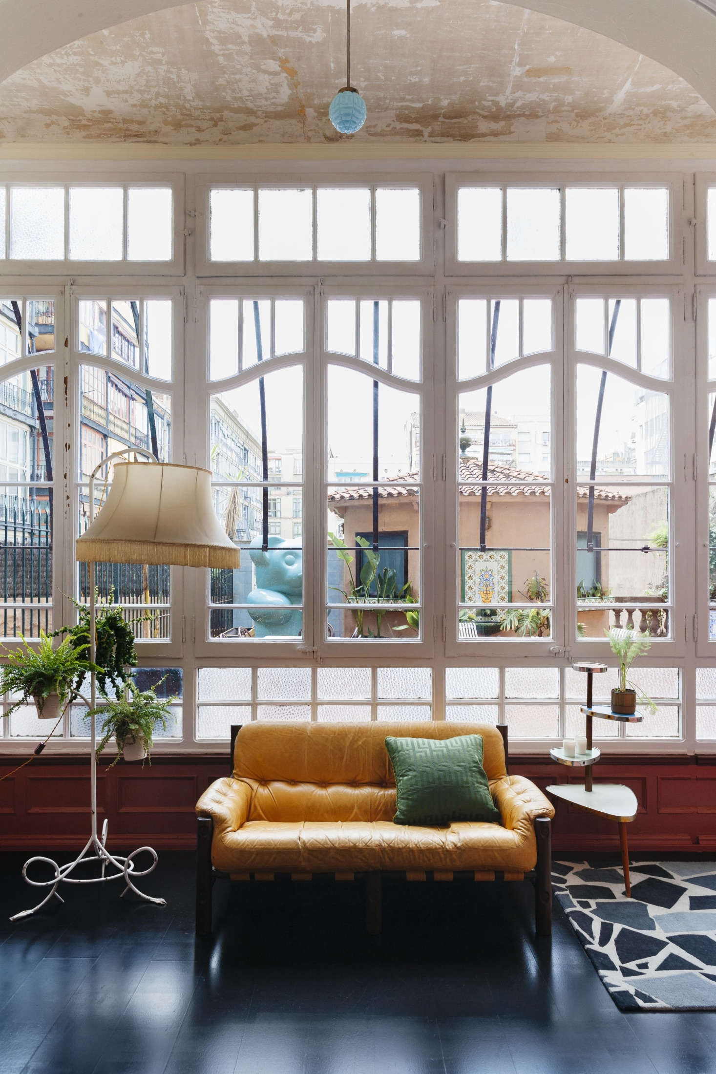 The room overlooks a roof terrace with a tiled pavilion. Just about all of the furnishings are flea market finds.