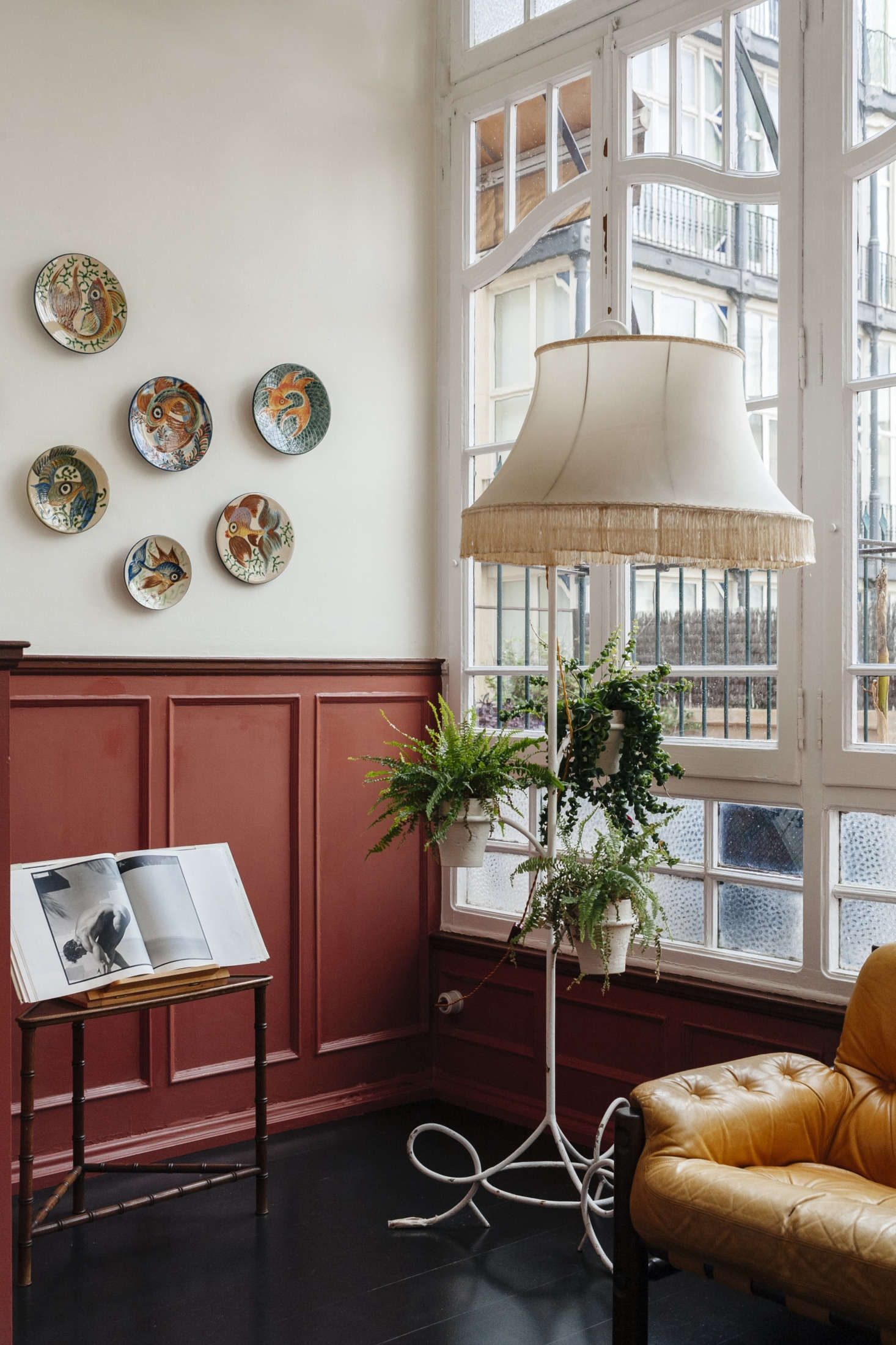 Fish-patterned majolica plates and a combination lamp and plant stand.