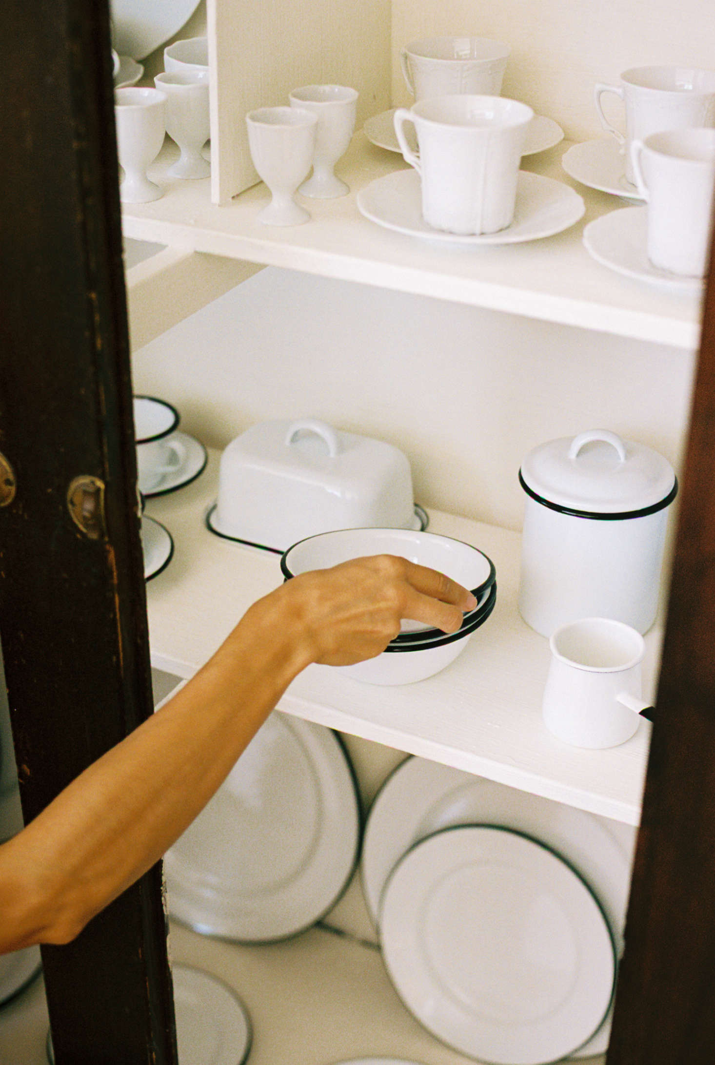 In the cabinet, a slew of enamelware, made in France and Belgium and starting at $6 for a small cup or bowl.