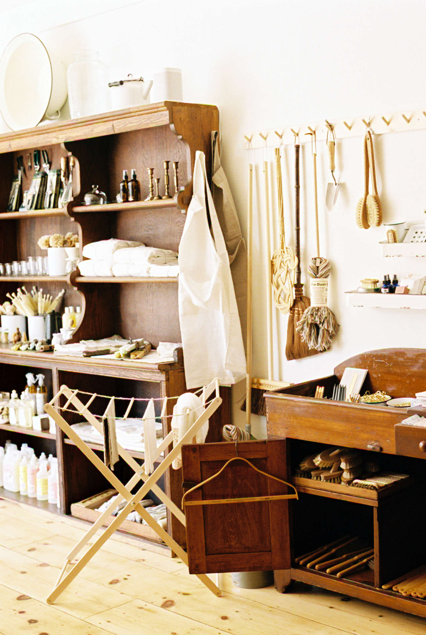 Utilitarian wares include brushes and brooms, hung from Shaker peg rails. Handmade Custodian brooms, also made in Brooklyn, are sometimes among the offerings.