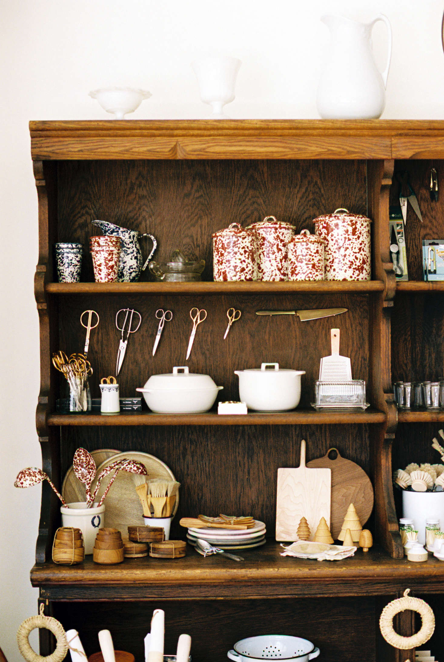 Another shelf is fully stocked with Splatterware Canisters (starting at $24), a Kakomi Donabe (the white ceramic vessel at left; $98 but currently out of stock online) and Kakomi Rice Cooker (right; $80), and scissors of all shapes and sizes.