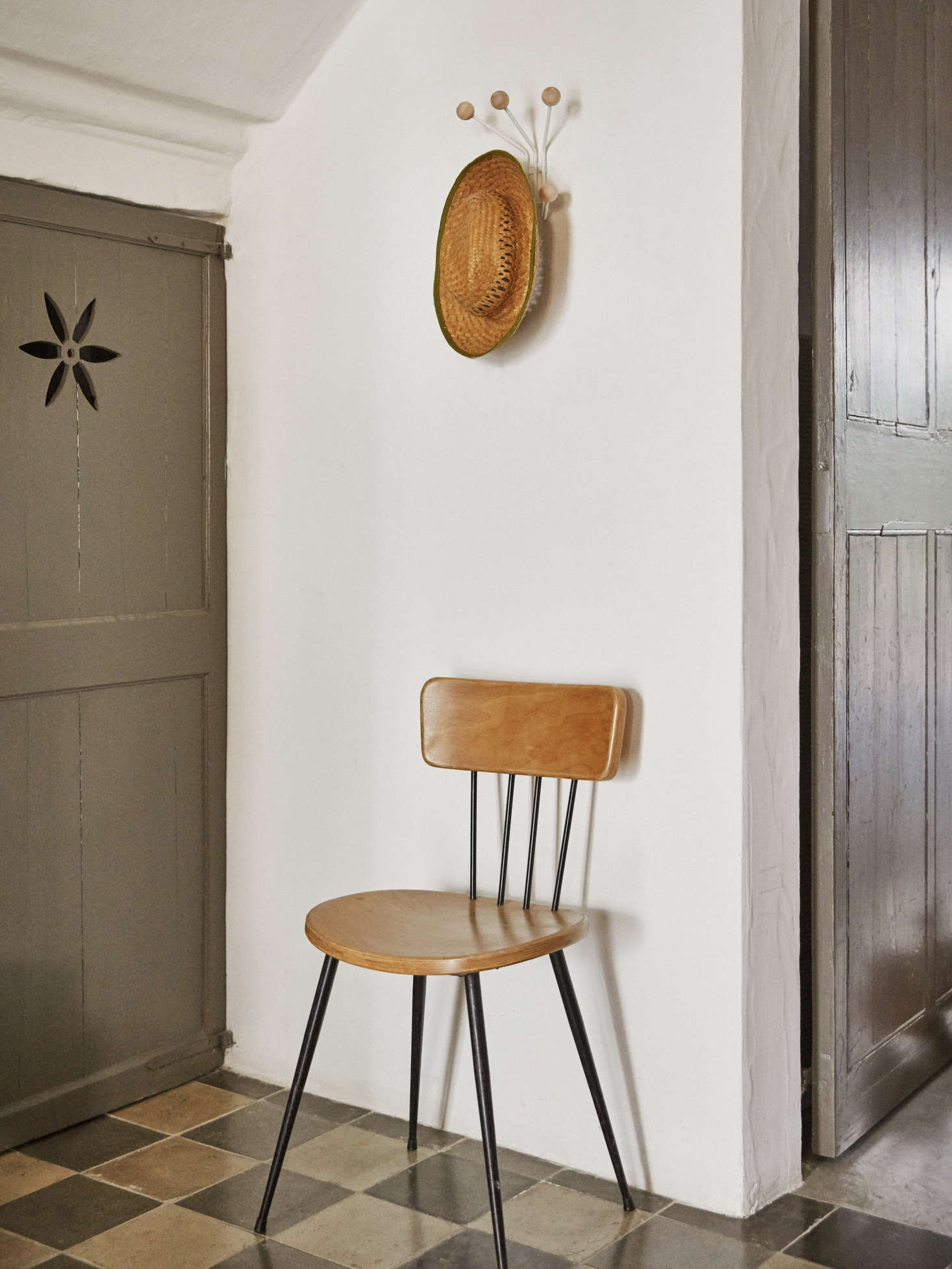 The original tiles from 44, a vintage chair, and the Maze Bill Coat Rack at the base of the stairs.