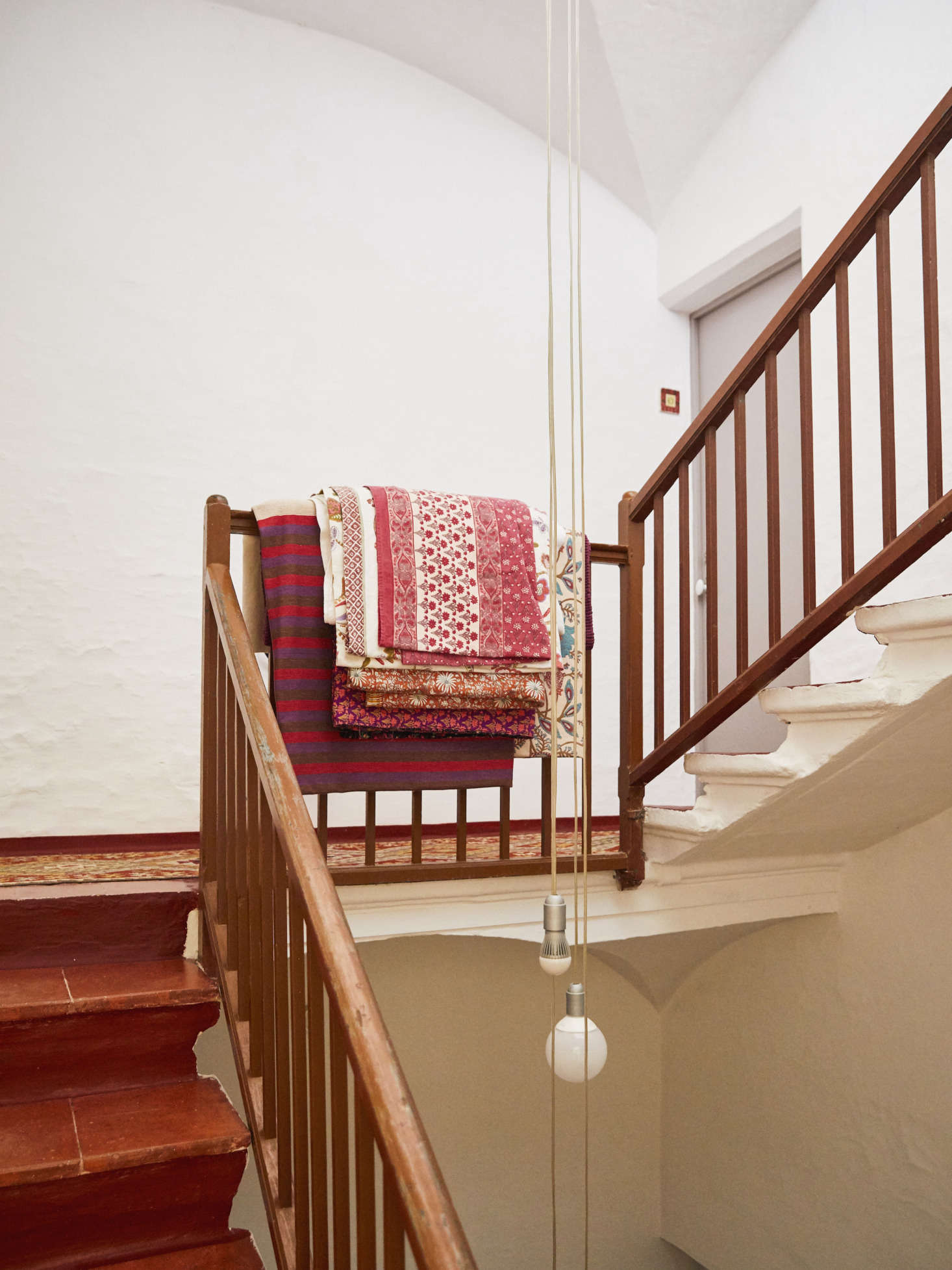 Layers of vintage blankets anchor the eclectic decor.