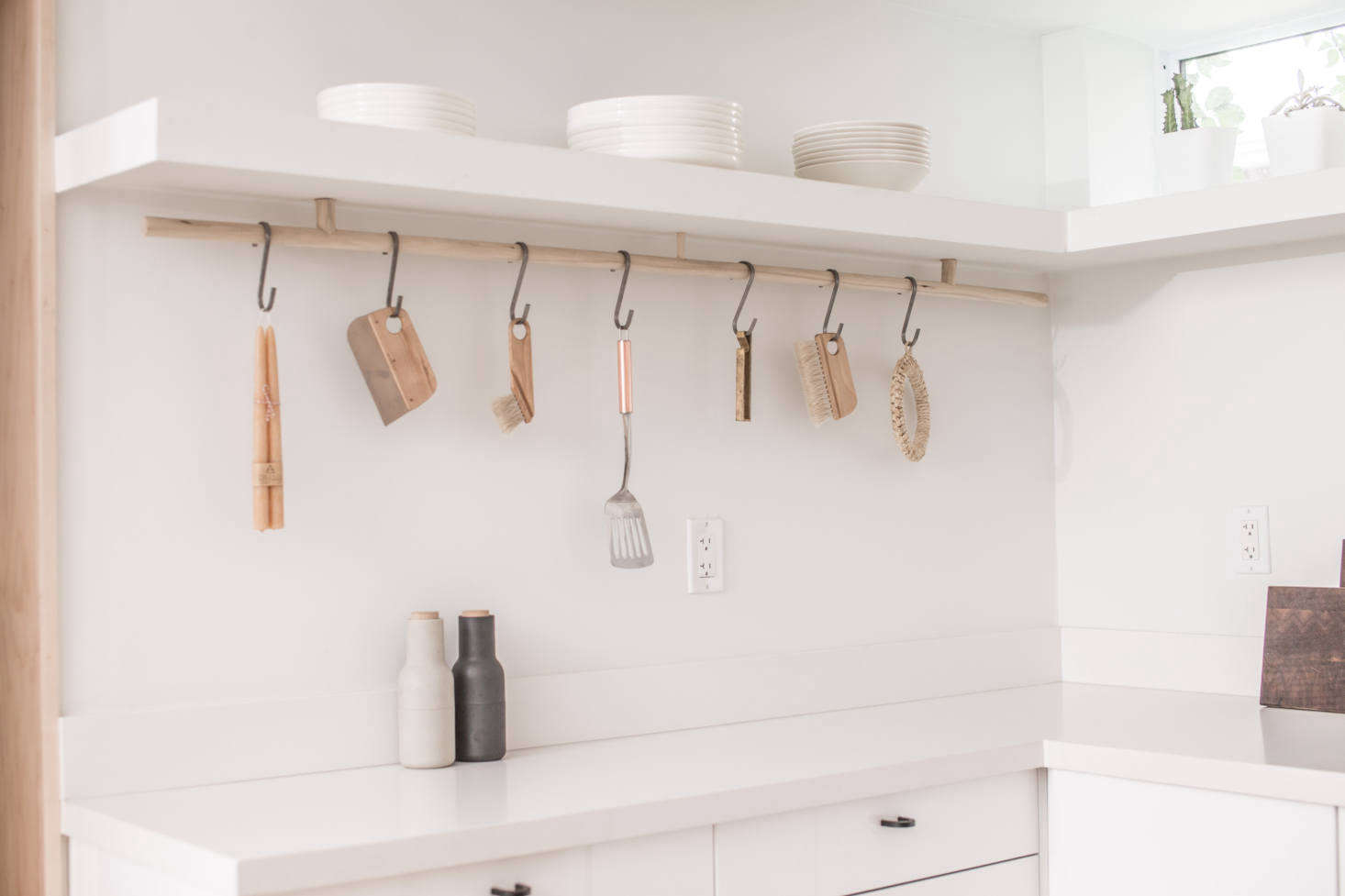 A custom wood rod and S hooks provides hanging storage.