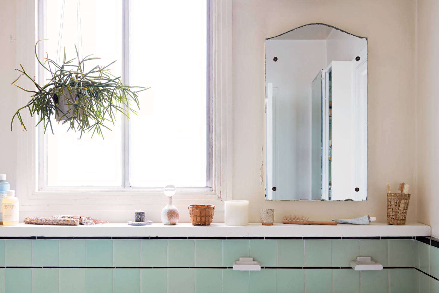 “Look for site-specific opportunities,” the couple writes: In their Great Highway apartment, Mitnik-Miller and St. Peter made use of existing tile by installing a slim piece of framing lumber, painted white, to serve as a simple shelf.