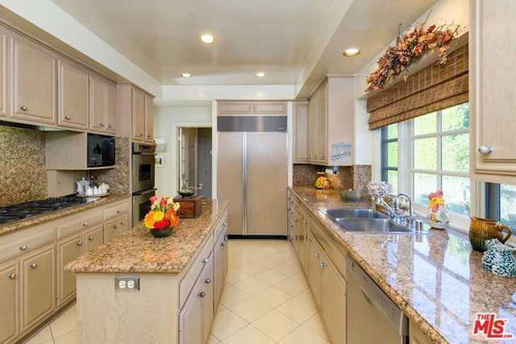 The kitchen was the only part of the house that had been remodeled in recent decades, during the era of speckled granite. The adjacent breakfast room became the wine cellar.