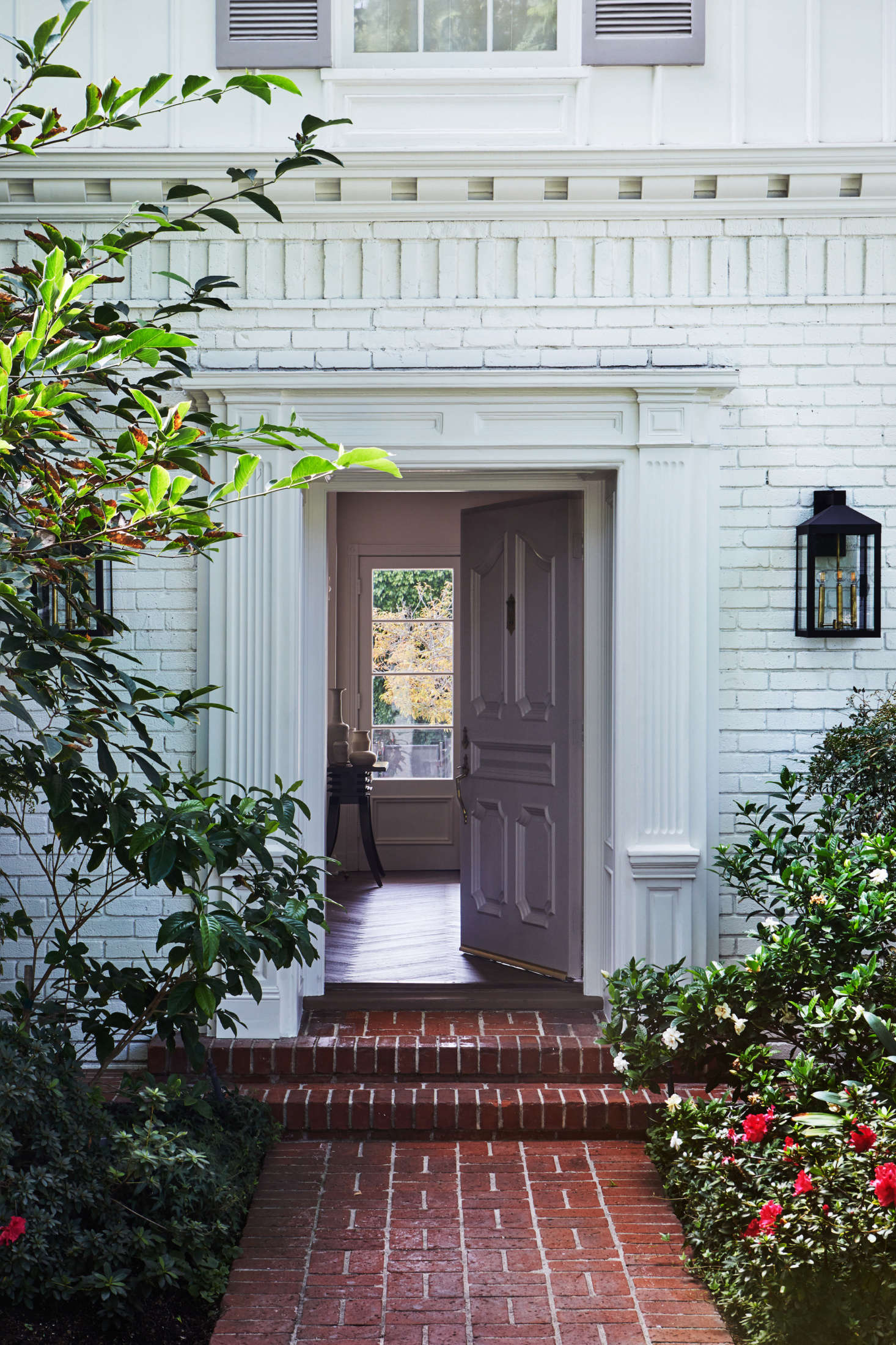 The red brick was whitewashed, but otherwise the exterior was preserved as is. (Because of tall hedges, Dick explains, it