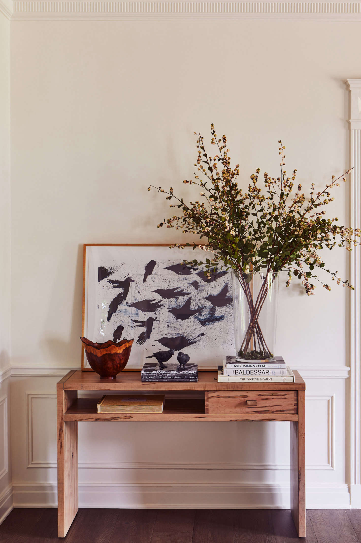 A custom console table displays a Ross Bleckner painting.