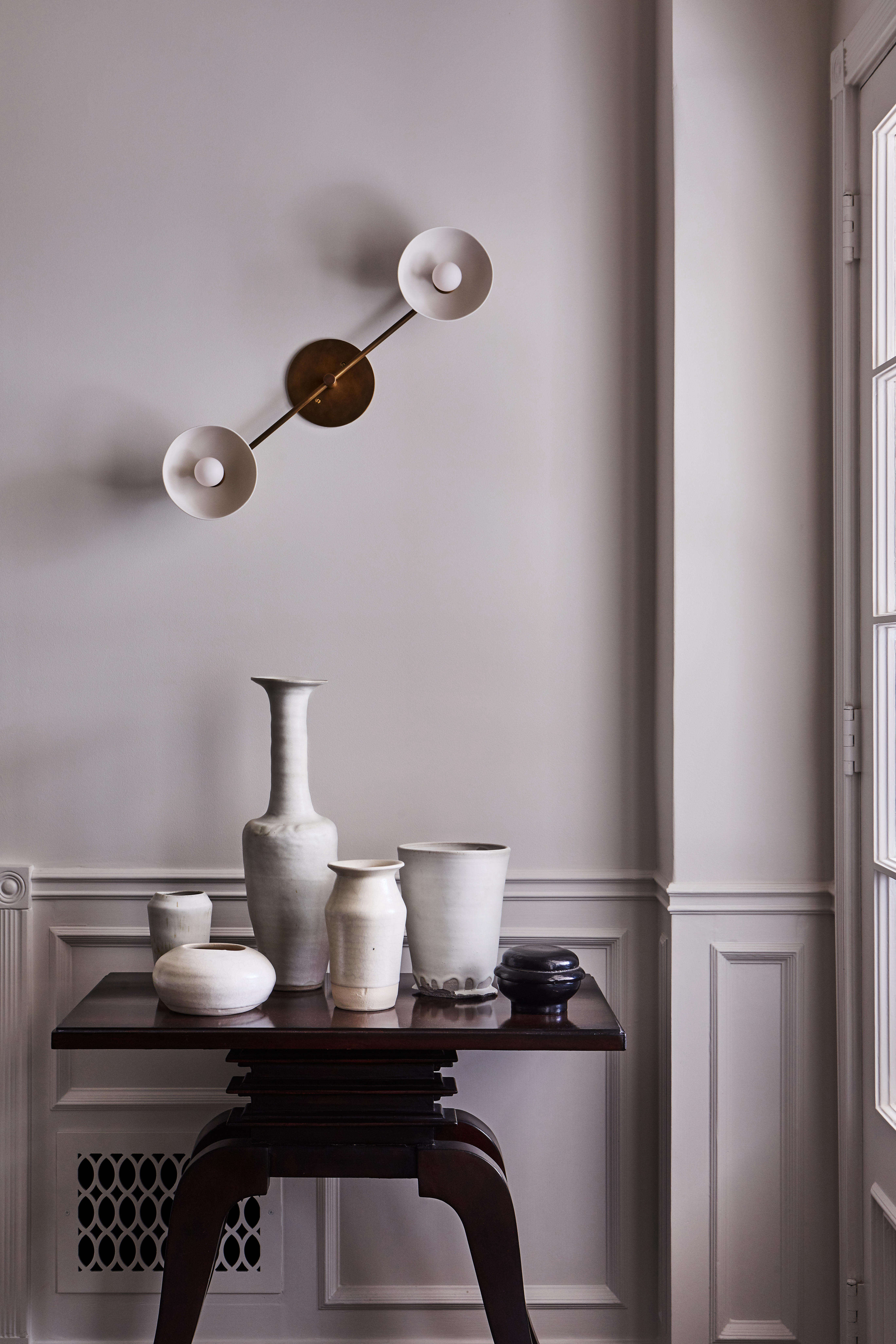 In the entry, a collection of ceramics by LA-based French artist Emilie Halpern is paired with Apparatus
