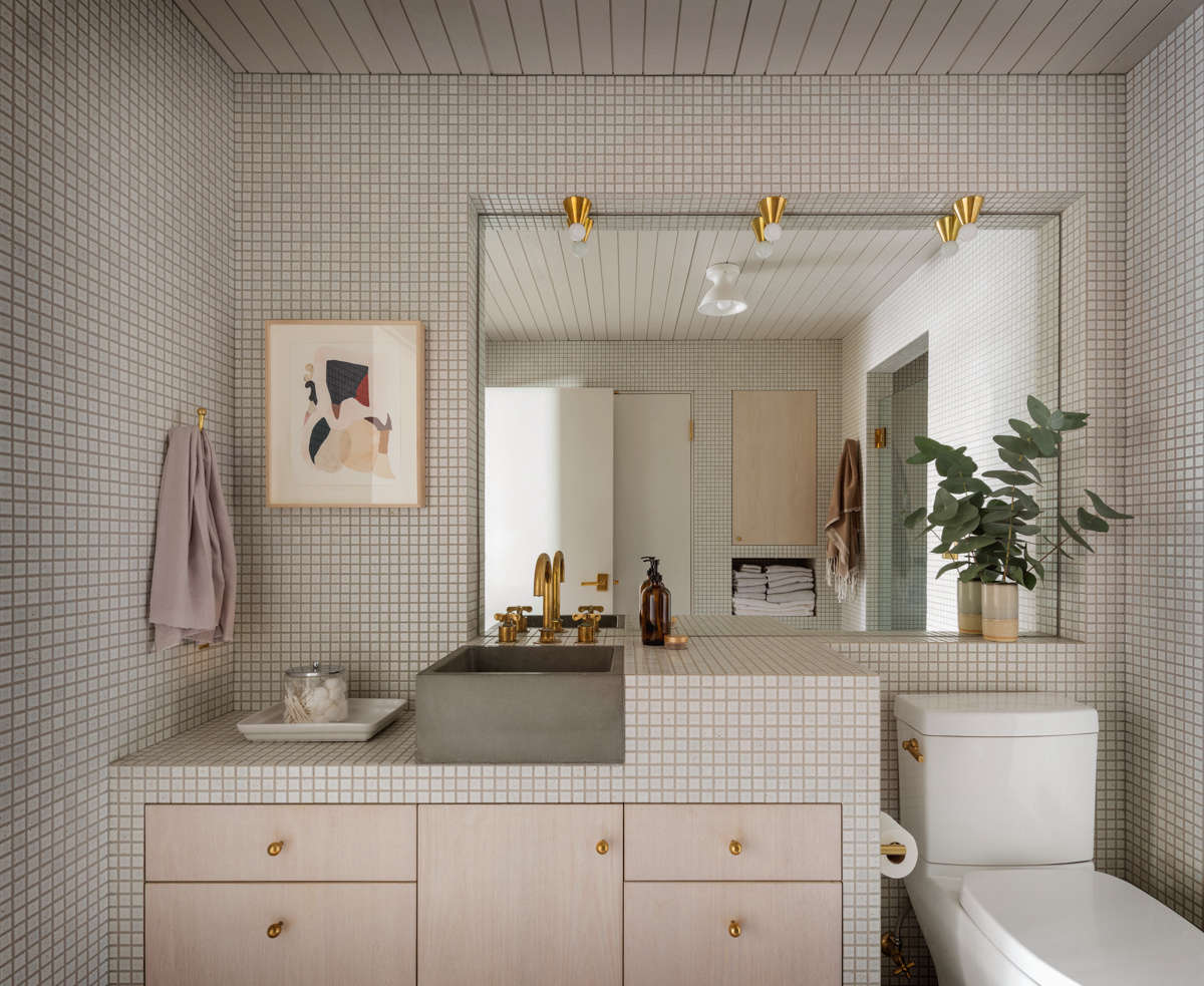 The bathroom is tiled in the same square-inch tile as the kitchen, for cohesiveness, and the sink is also by Cement Elegance.
