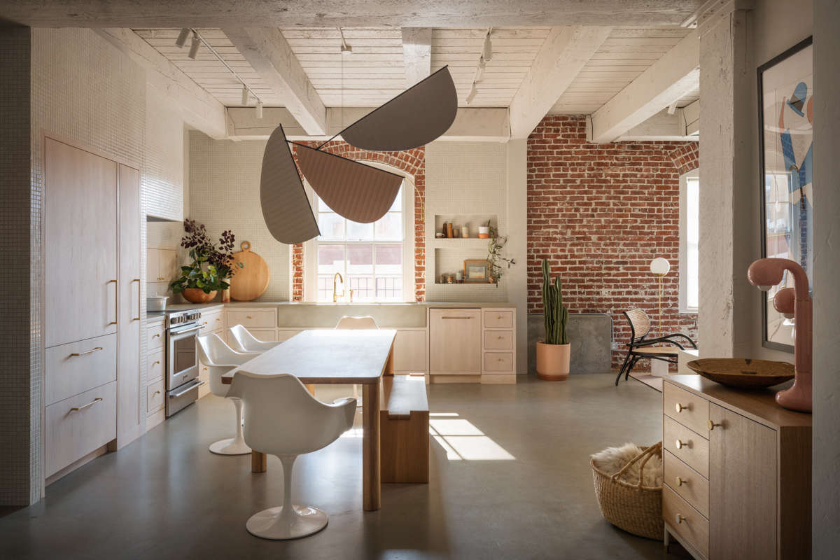 The kitchen opens into the living room, at right. Williams gave away nearly all of her furniture as part of the process, 
