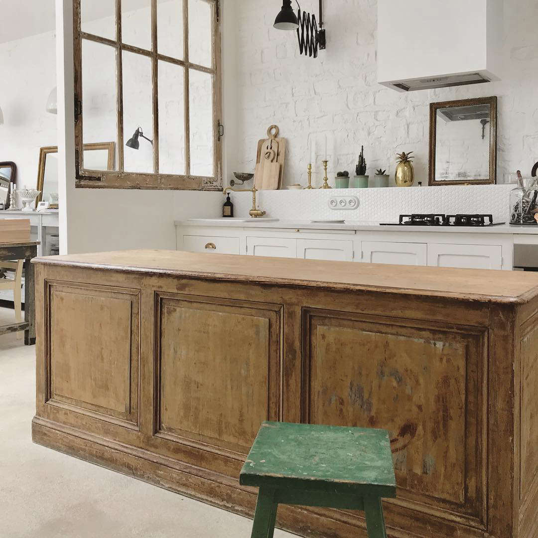 A fool-proof way to add character to any kitchen: bring in old furniture pieces. Here, a weathered buffet serves as kitchen island.
