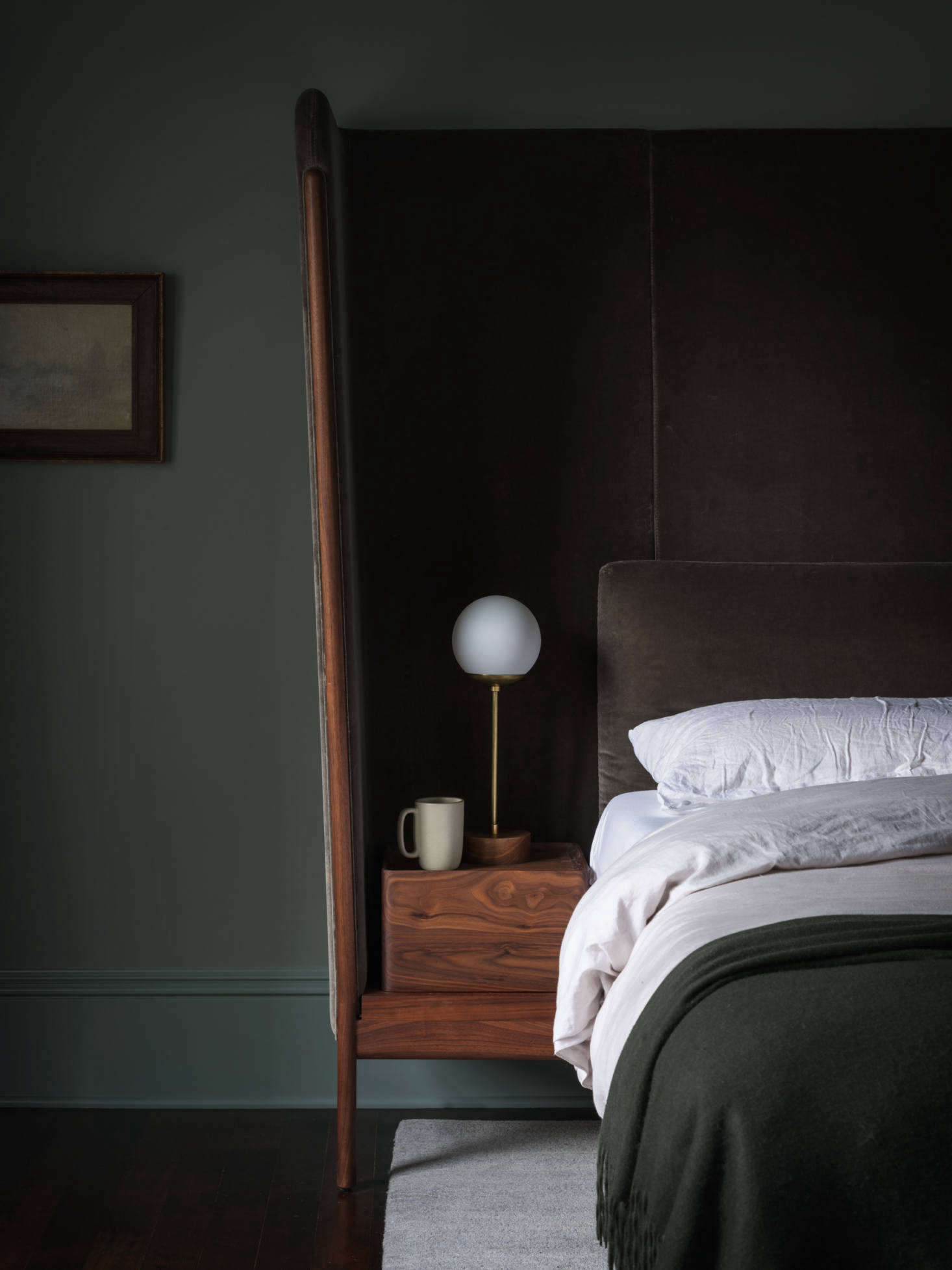 Neri & Hu also designed the bed with built-in nightstands. “It’s upholstered in cotton velvet and capped with walnut,” she shares. The bedstand lamp is by LA-based Nino Shea.