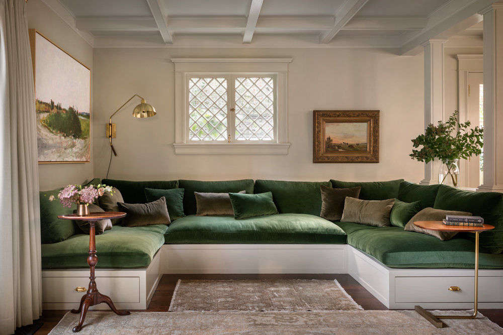 The family room is anchored by a built-in sofa, big enough to comfortably fit the clients and their two children, topped with plush cushions in a sumptuous green velvet.