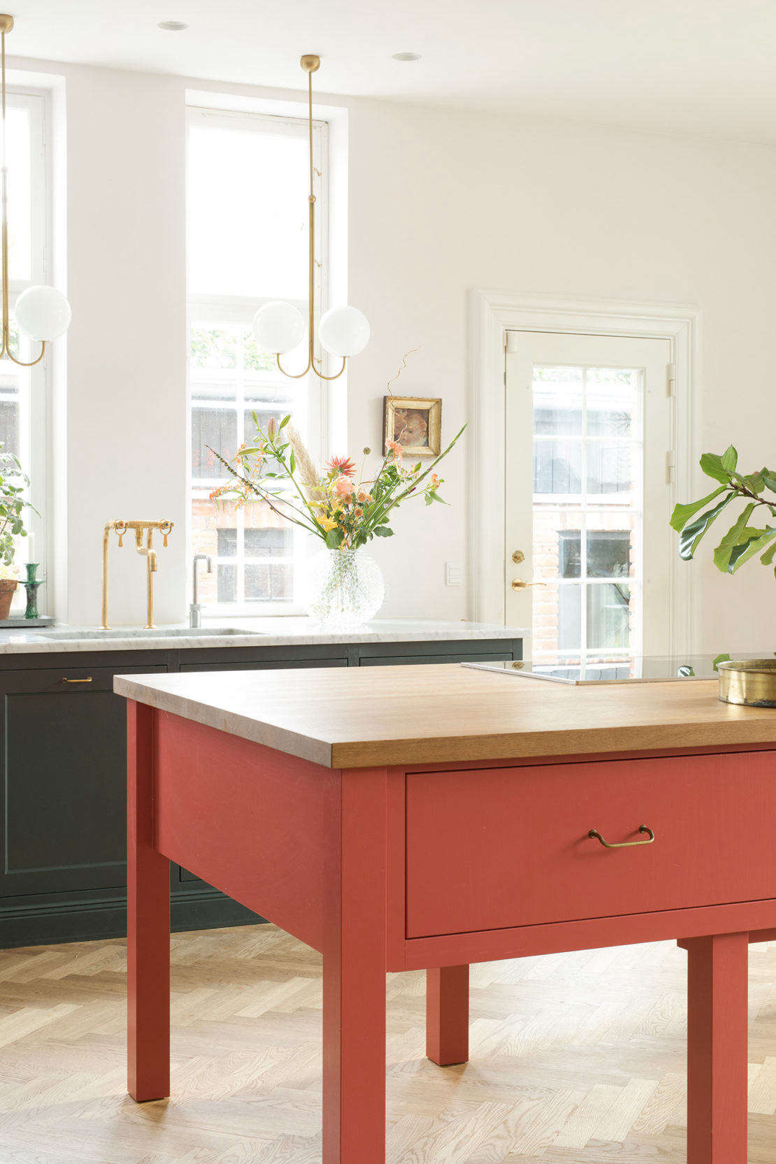 The oak island is designed as a work table with an inset stove top. Inspired by Plain English