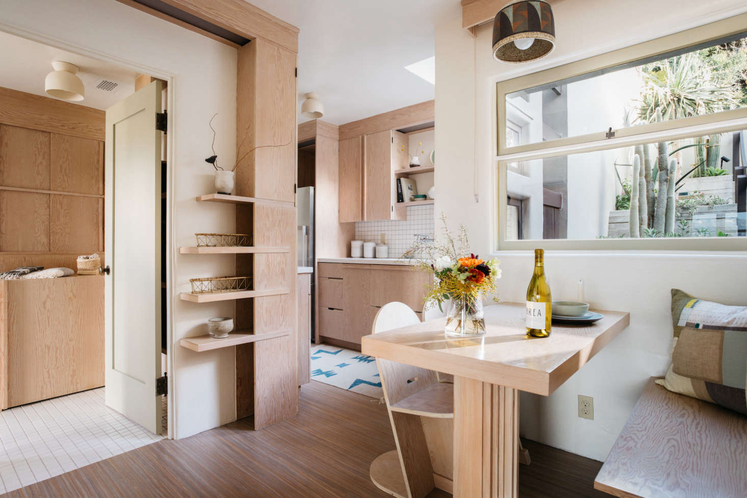 A view of the bath (left), dining area, and kitchen (back). Photograph by Virtually Here Studios.