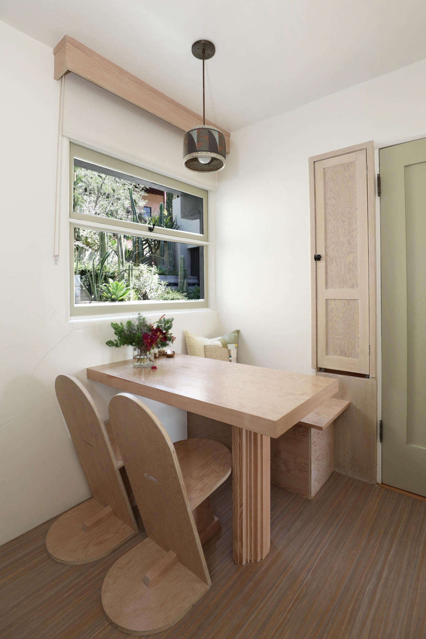 Luis Guerra Woodworking custom-made the breakfast nook, including the bench and pedestal table (which took two days to fabricate). “The two chairs are are re-creations of chairs that Schindler designed for the property, which sold for $10,000 each. The seat was widened and the slant of the back support was changed slightly to make the chairs more comfortable,” shares Finegold.