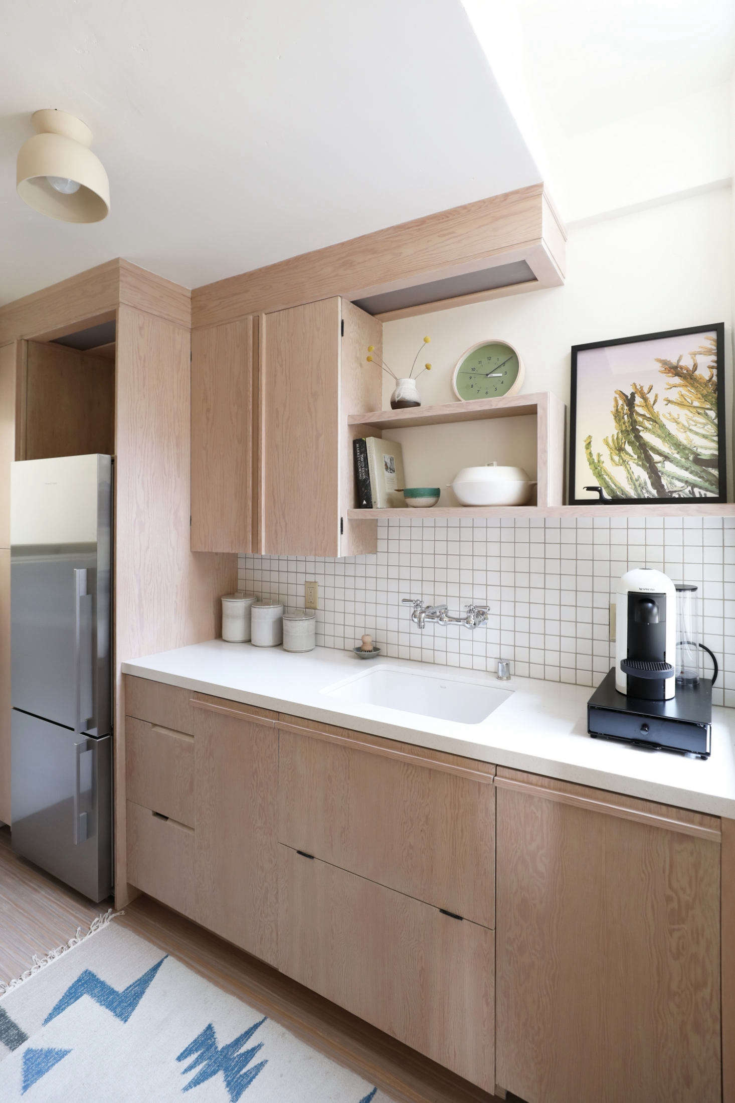 All the cabinetry and built-in shelving throughout the unit were based on designs in the original apartments. (See 10 Easy Pieces: Wall-Mounted Industrial Faucets for similar faucets.)