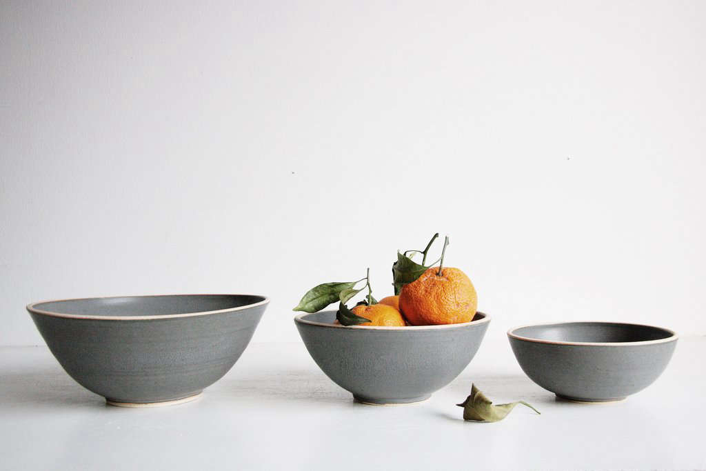 The hand-thrown Silverlake Nesting Bowl Set comes in four colors: serenity blue, classic white, satin black, and charcoal (pictured); $3 for a set of three bowls from Sheldon Ceramics. (Featured image shows the other colors available.)