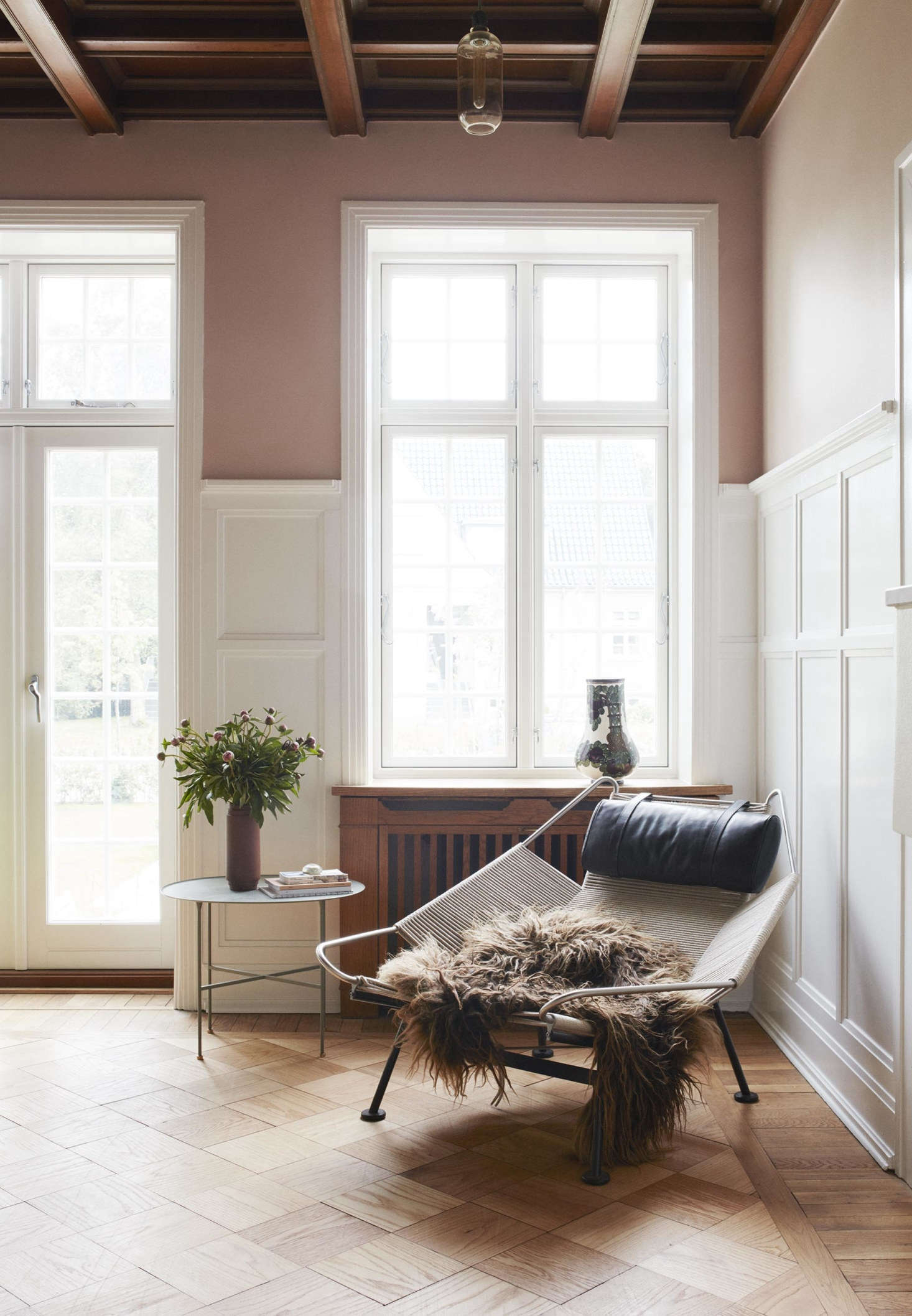 In another corner, a sheepskin is slung over a Wegner PP