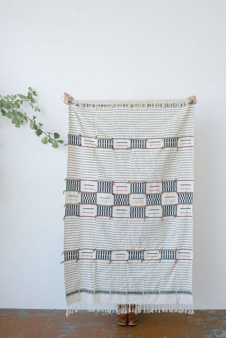 Each piece takes anywhere from one to five days to complete. The durable cotton fabric is pet-friendly. The Adjoukrou Throw is $200.
