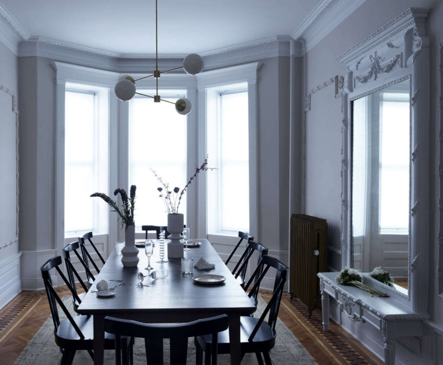 In the dining room, pale paint—Benjamin Moore’s Collingwood in a matte finish at 25 percent dilution—lends a slightly ghostly feel. The molding here, including the original built-in mirror, is painted over in Benjamin Moore’s Decorator’s White in semi-gloss.