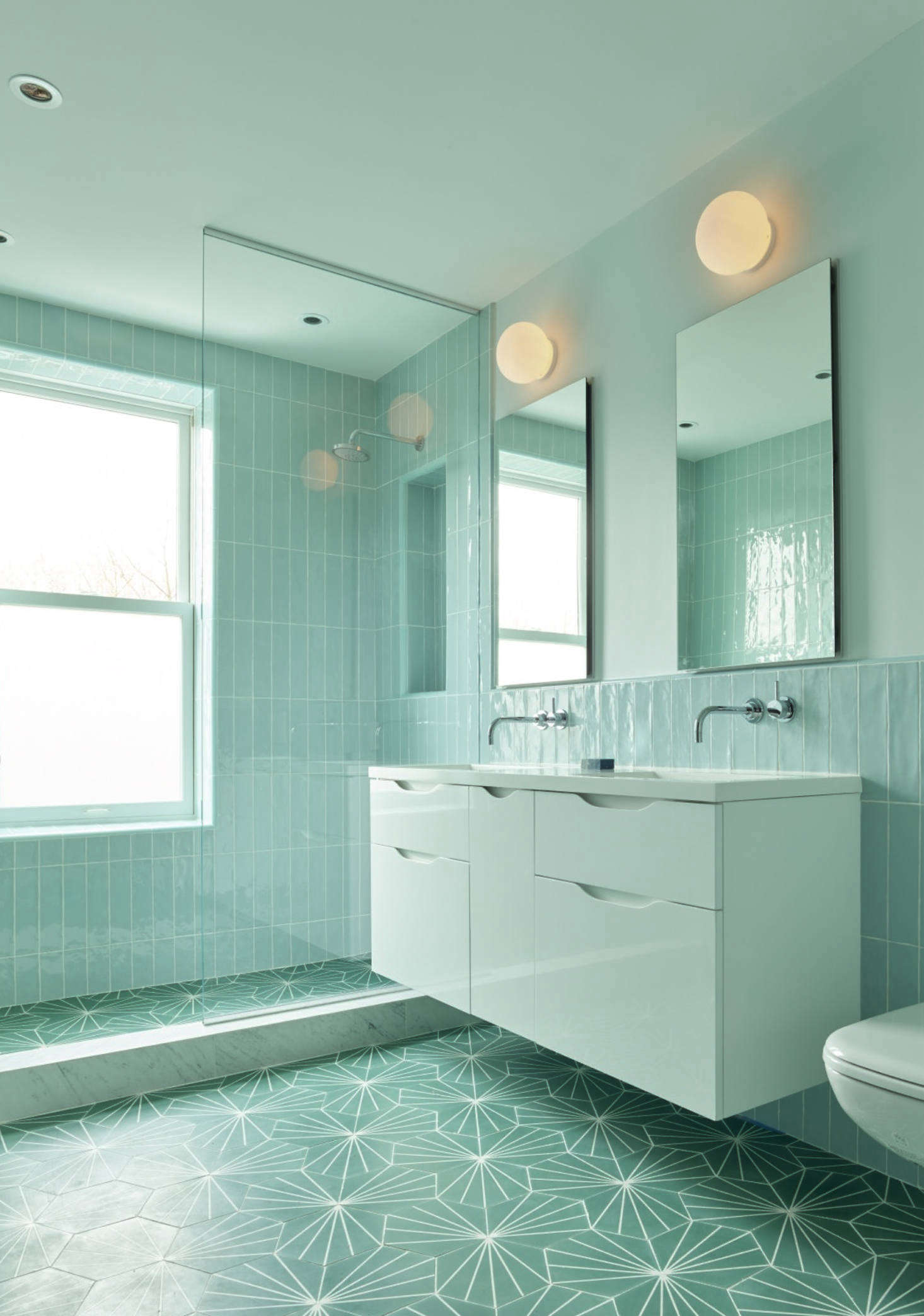 The girls’ bath, in tone-on-tone sea-foam green, a collaboration between Spain and Kocher, the architect.