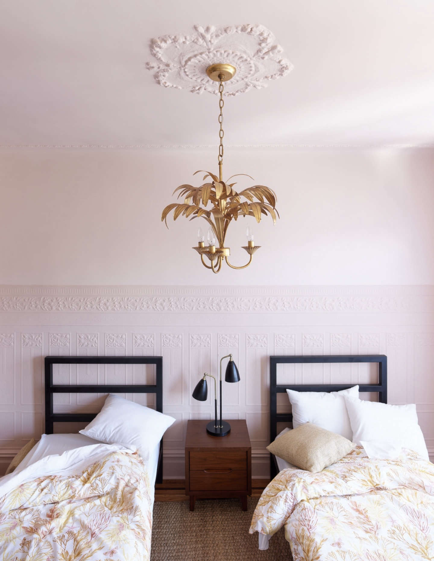The girls’ room has a pink-on-pink scheme tempered by black and a bit of irreverence.