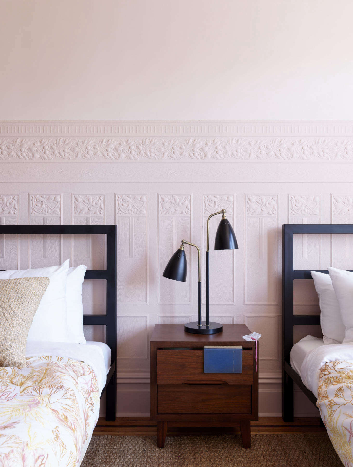 Clean lines counteract the soft pink paint color, which is Benjamin Moore’s Odessa Pink—at full saturation to the top of the floral paneling, and at 50 percent dilution above it.