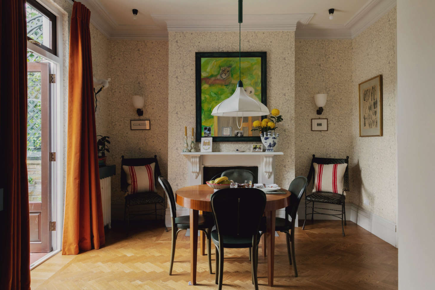 “People often seem to see vibrant, eclectic interiors like the ones I design in direct opposition with minimalism, but I don’t think that’s necessarily the case,” says Heuman. Case in point: the dining room, which feels at once visually rich and appealingly spare. Gemla chairs, upholstered in leather (note the zipper on the back), surround a vintage table. The Snowdrop Rise & Fall ceiling light is a Heuman creation.